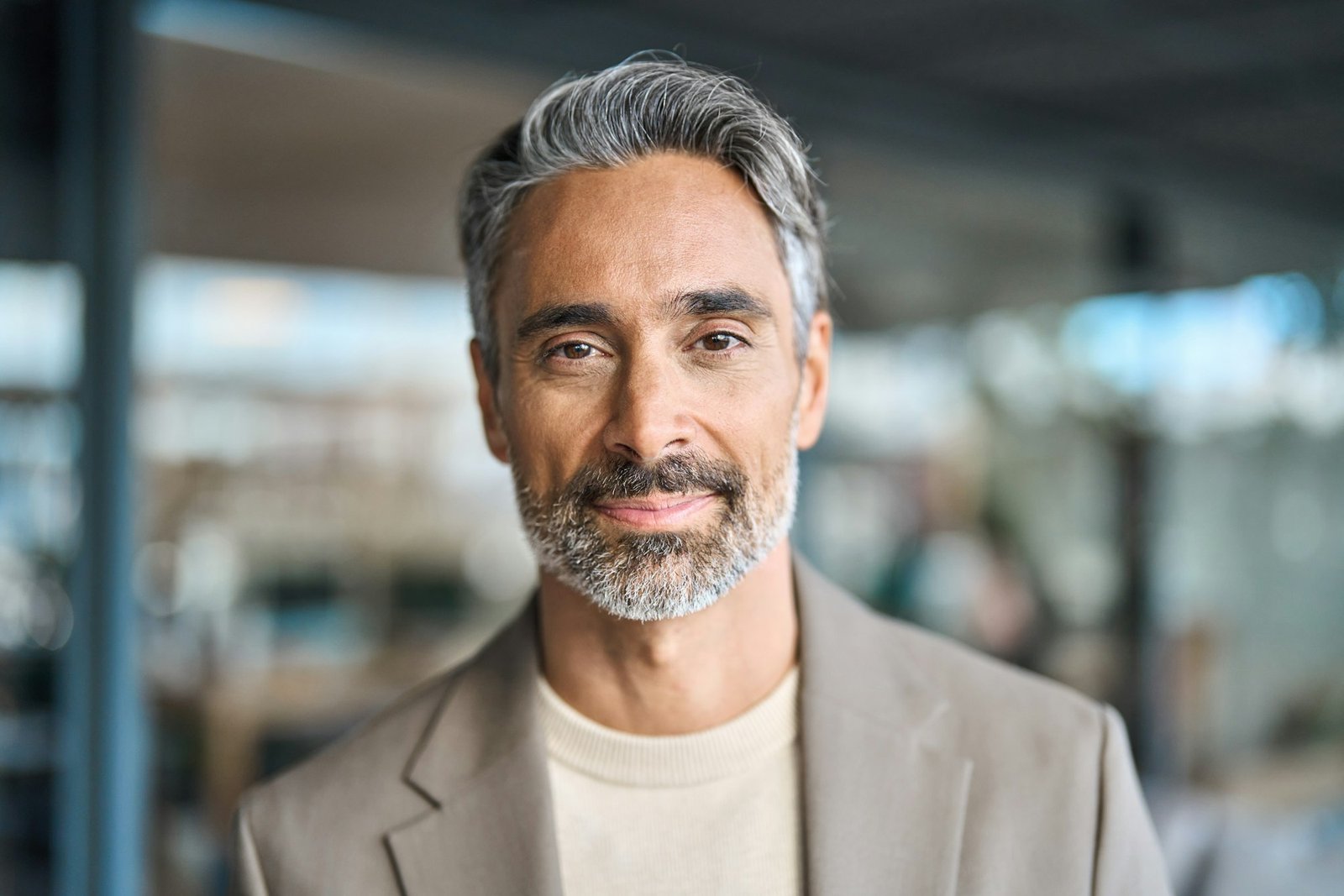 Happy middle aged mature business man looking at camera in office, headshot.